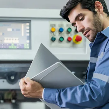 Técnico analisando medidor de vazão em painel de controle industrial